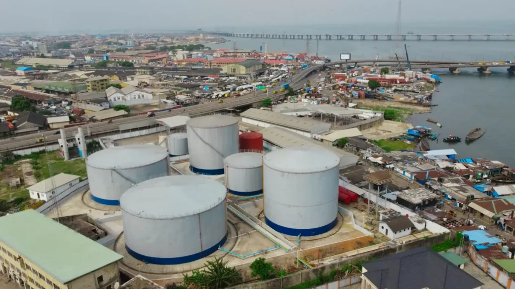 Industrial storage tanks beside the Lagos cityscape
