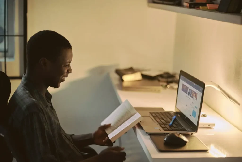 Nigerian professional working on a laptop